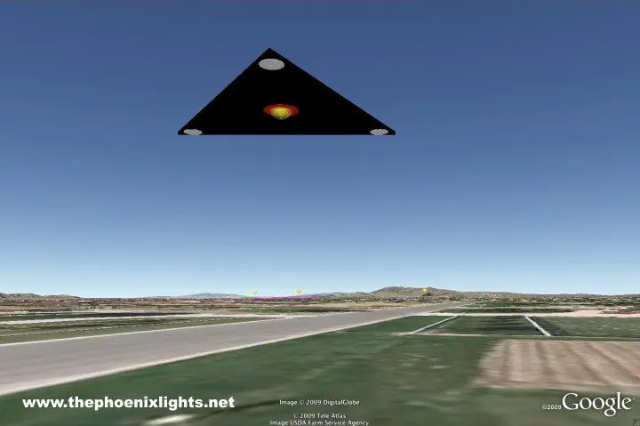 Here's an alt tag for the image: Triangular UFO over desert landscape.