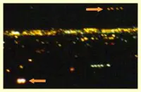 Here's an alt tag for the image: Nighttime city lights with two objects indicated.