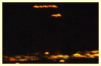 Here's a short alt tag for the image: > Night sky, blurry lights, possible UFOs.