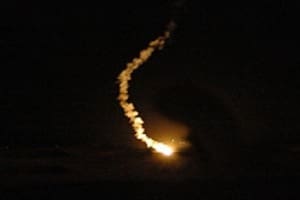 Here's an alt tag for the image: `Missile launch at night`