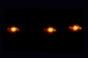 Here's an alt tag for the image: Three distant galaxies in deep space.