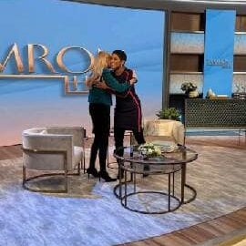 Two women hugging on a talk show.